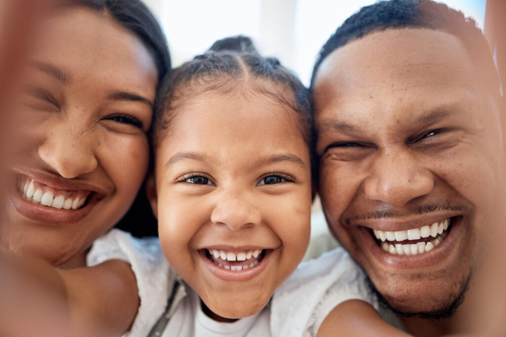 close up of young family smiling