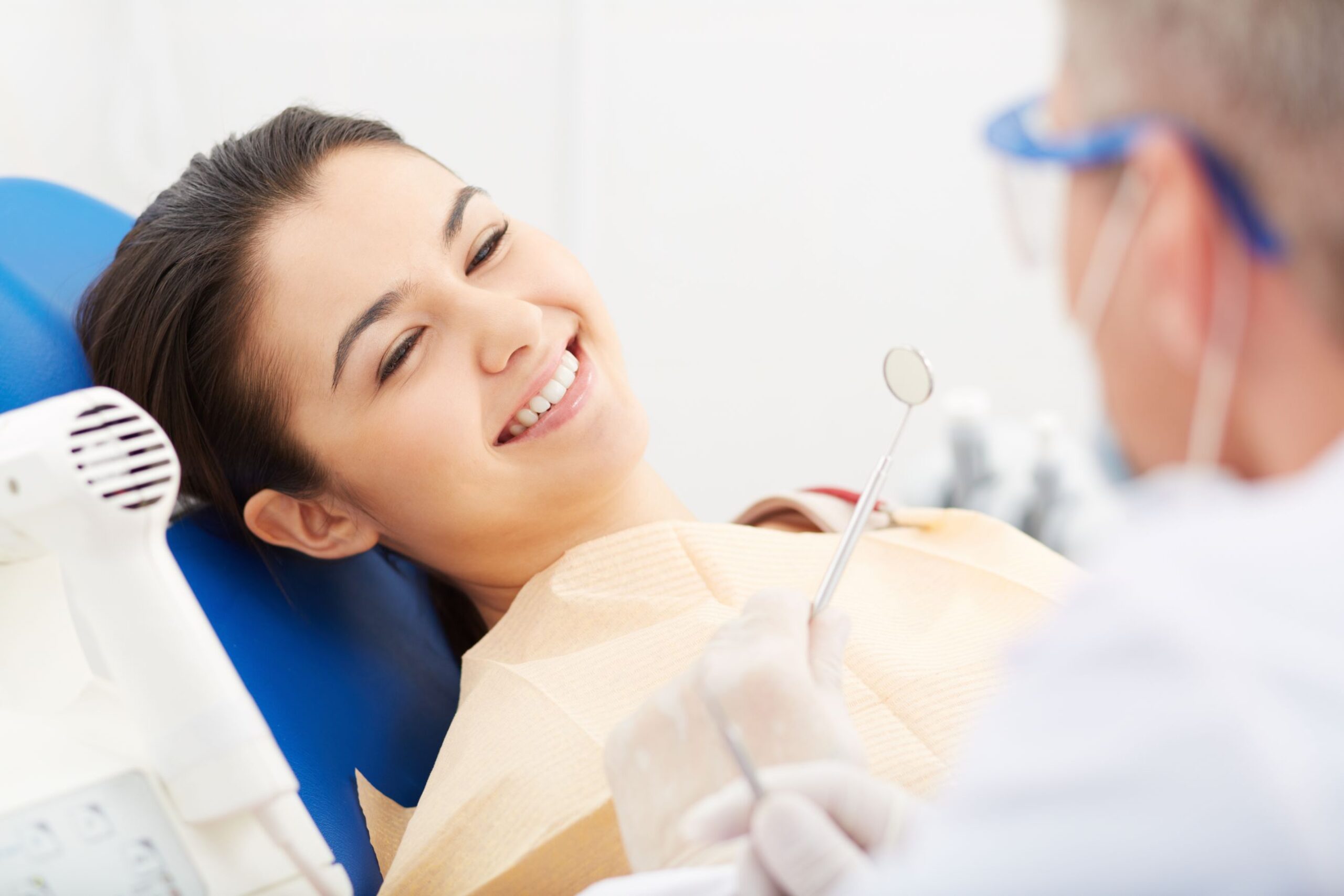 Young adult patient preparing for treatment with dentist